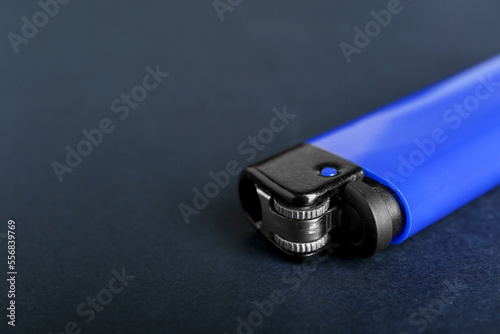 Stylish small pocket lighter on black background, closeup. Space for text © New Africa