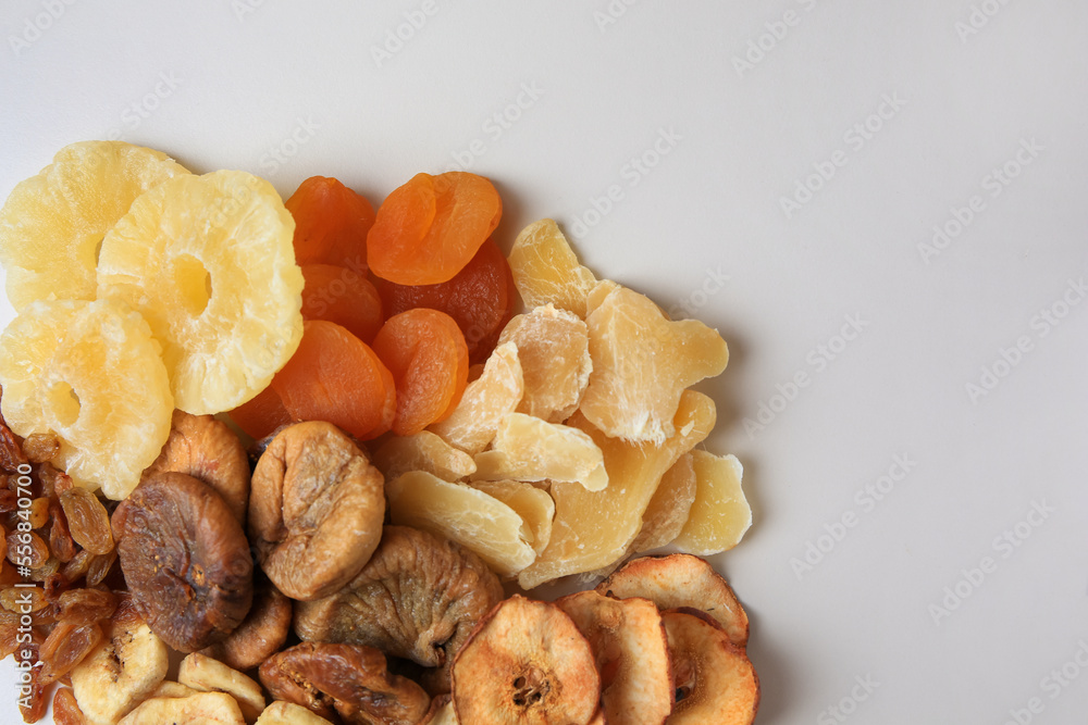Fototapeta premium Pile of different dried fruits on white background, top view. Space for text