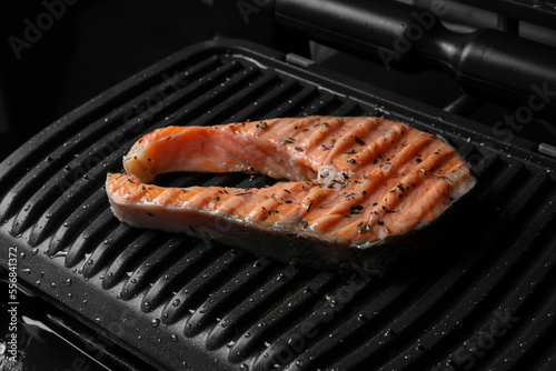 Cooking salmon. Grill with tasty fish steak and spices