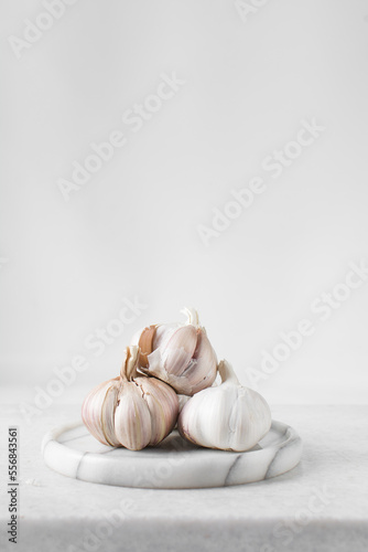 Garlic bulbs on a marble tray, garlic, raw garlic, Allium sativum