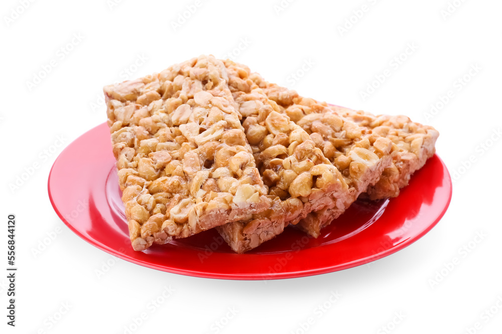 Plate with tasty peanut bars (kozinaki) isolated on white Plate with tasty peanut bars (kozinaki) isolated on white