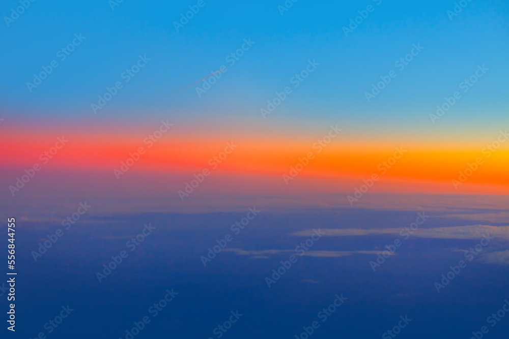 Sky with colorful dusk . Vibrant sky view during flight