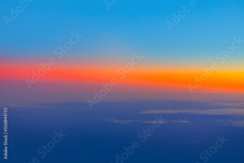Sky with colorful dusk . Vibrant sky view during flight