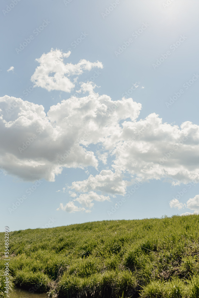 hillside with blue sky and clouds