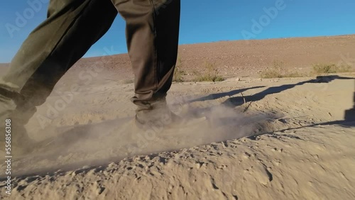 Walking on desert dusty dirt road photo