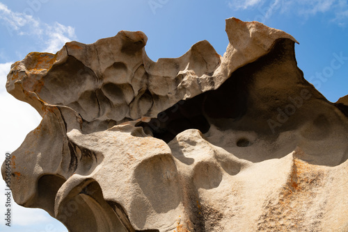 Remarkable Rocks in Flinders Chase National Park on Kangaroo Island, South Australia. Rocks covered by golden orange lichen. Black mica, bluish quartz and pinkish feldspar comprise most of the granite photo