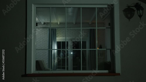 Man caught during a house robbing by the police. Close-up view of unrecognized man in black balaclava stealing money while the owners are out. High quality 4k footage