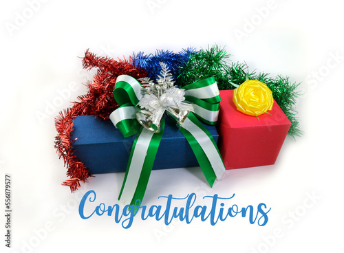  Close up image of gift box with green luxury ribbon and bow. Gift Box with Shiny Green Satin Bow and Ribbon on with text by handwritten congratulation,  Congratulations  Card Celebration Of Holidays  photo