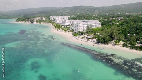 Jamaican Coast on Caribbean Sea, Aerial View of Sandy Beach and Beachfront Buildings in Ocho Rios photo