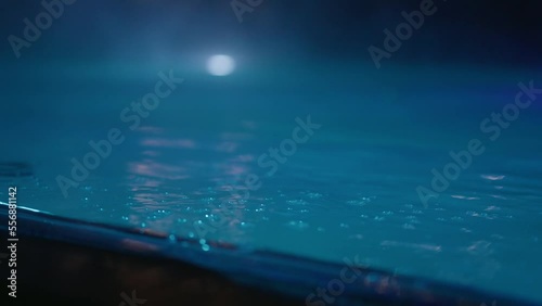 Closeup of Bubbles in pool at night photo