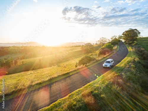 4x4 car driving on country road trip adventure on narrow road at sunset photo