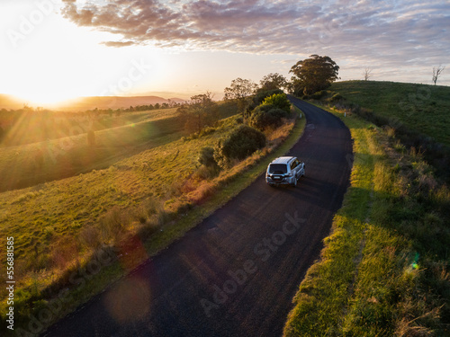 4x4 car driving on country road trip adventure on narrow road at sunset
