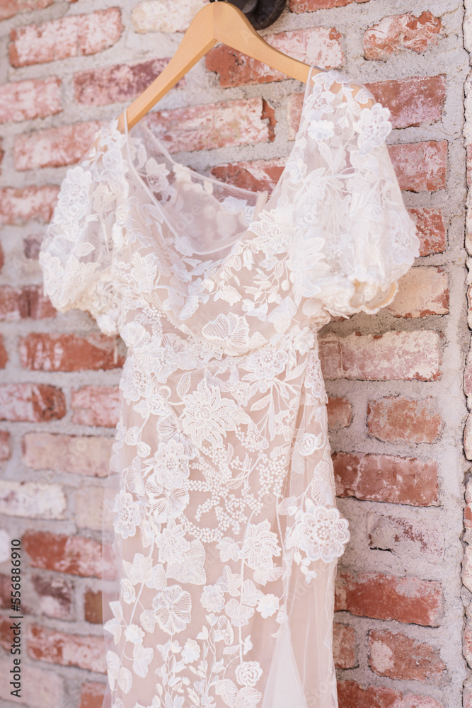 bridal dress hanging on the wall in summer day bridal dress hanging on the wall in summer day