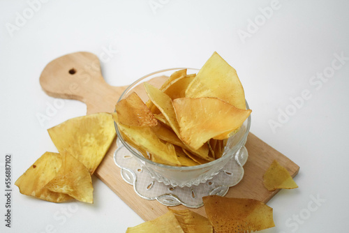 Kripik Sukun or Breadfruit Chips Served on Small Bowl in White Background photo
