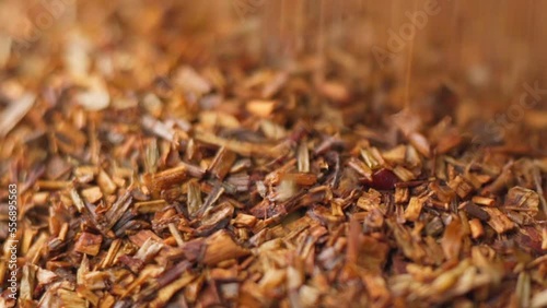 Rooibos or redbush tea leaves. Selective focus. Rooibos, a traditional drink in South Africa. Organic Tea. Slow motion photo