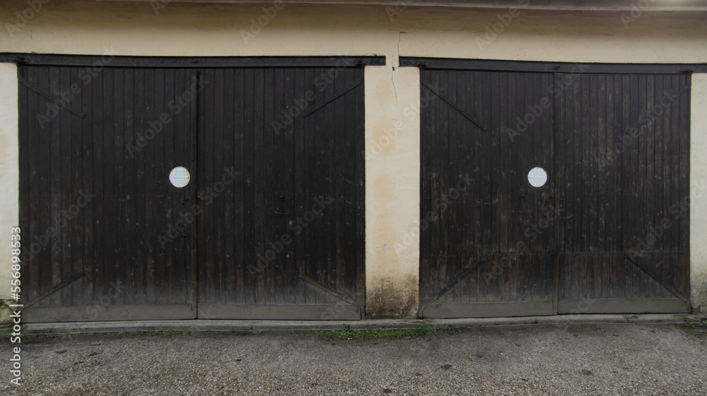 gate wooden home portal garage double door house wall facade Stock