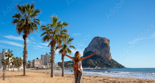 Woman looking at Calpe rock and mediterranean sea in Spain