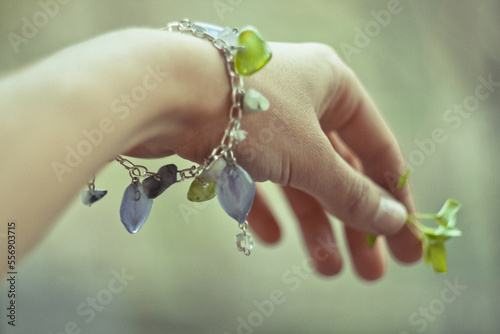 Close up stylish bracelet on female wrist concept photo. Craft jewelry. First view hand photography with blurry background. High quality picture for wallpaper, travel blog, magazine, article