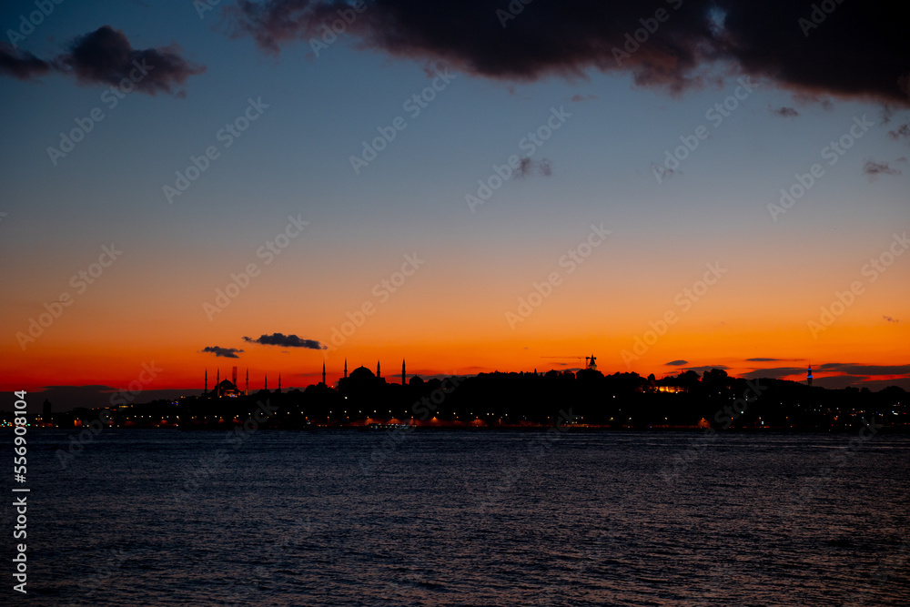 Istanbul. Silhouette of Istanbul at sunset with clouds on the sky.