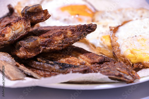 Fried bangus or milkfish with easy made eggs, served while hot. Deep fried fish. Filipino cuisine.