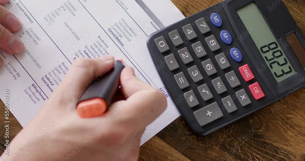 Freelancer examines and tries to compare digits on paper with calculator. Businessman carefully explores detail financial report of business project closeup Freelancer examines and tries to compare digits on paper with calculator. Businessman carefully explores detail financial report of business project closeup