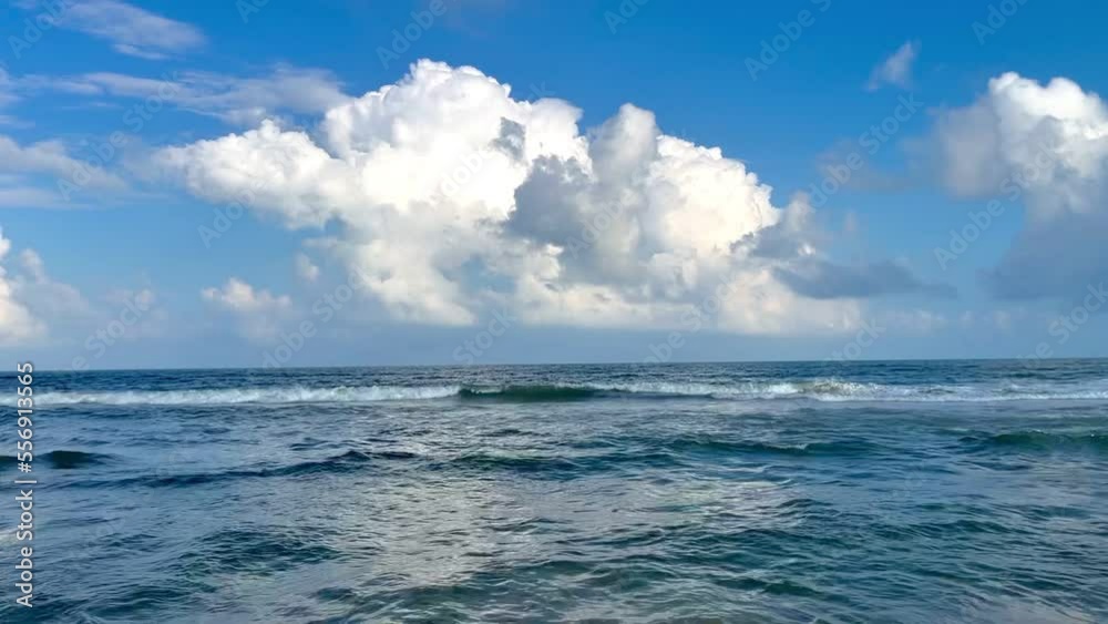Sea waves near the ocean surface and the moving clouds landscape view