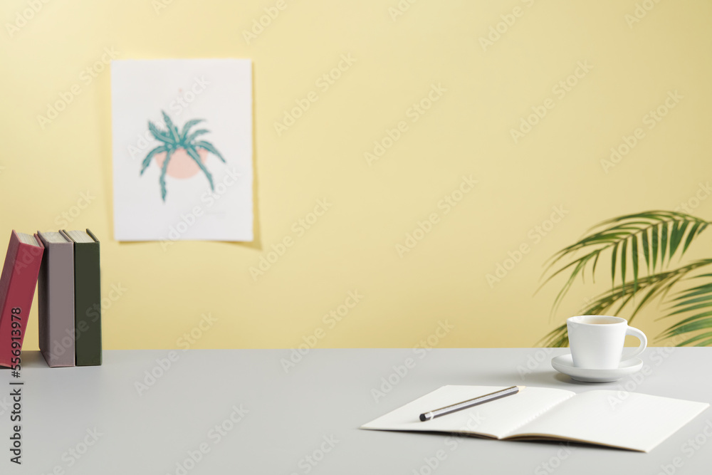 casual office desk with bright yellow background casual office desk with bright yellow background