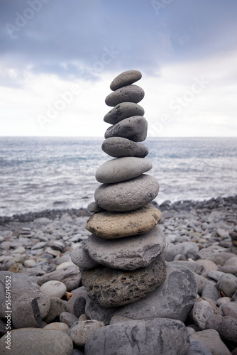 Tall balanced stack of pebble stones on a stony beach in Madeira, Portugal.