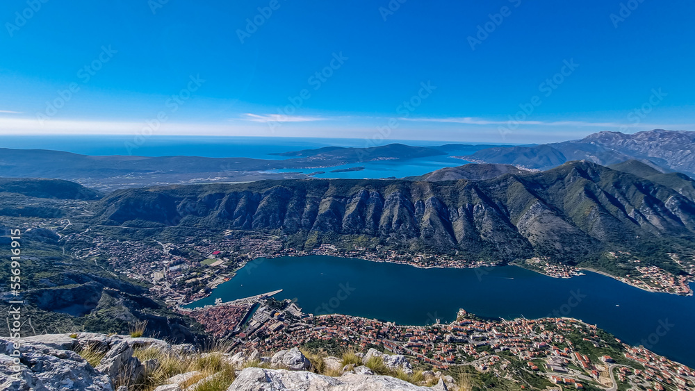Panoramic view from Pestingrad (Derinski Vrh) of Kotor bay in sunny summer, Adriatic Mediterranean Sea, Montenegro, Balkan Peninsula, Europe. Fjord winding along coastal towns. Lovcen, Orjen mountains
