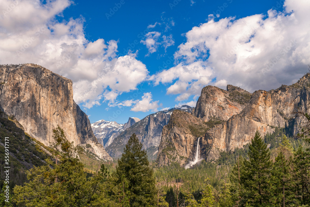 Majestic view on the valley of Yosemite with sun and few clouds, blue sky, Bridal veil fall and El Capitan Majestic view on the valley of Yosemite with sun and few clouds, blue sky, Bridal veil fall and El Capitan