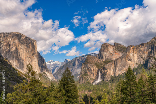 Majestic view on the valley of Yosemite with sun and few clouds, blue sky, Bridal veil fall and El Capitan 