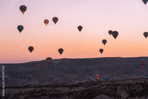 Balloons flying against the background of a beautiful sunrise in Cappadocia. A popular tourist destination for summer holidays
