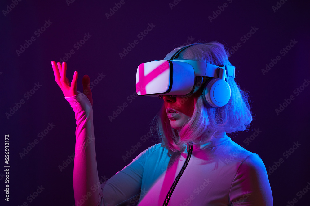 Woman in virtual reality goggle in neon colors.