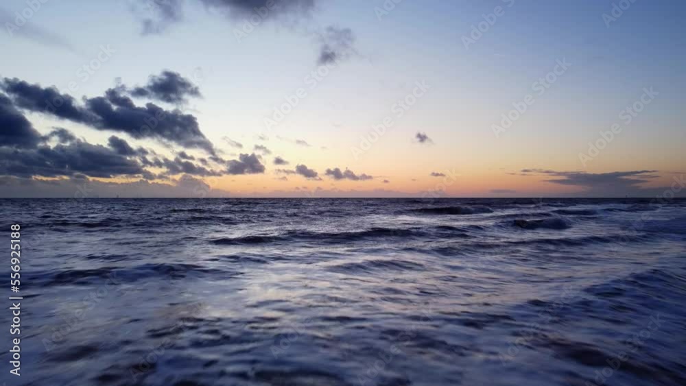 Drone flying fast and low over blue ocean water at beautiful sunset Drone flying fast and low over blue ocean water at beautiful sunset