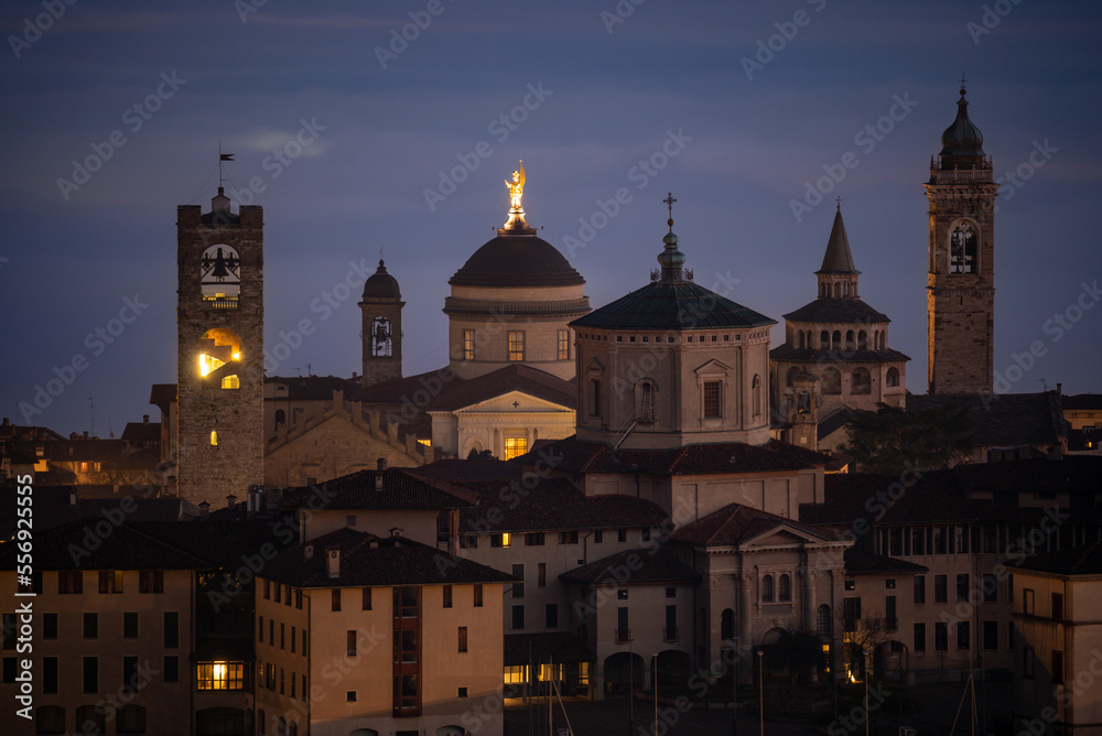 Naklejka premium Bergamo. One of the beautiful city in Italy. Landscape at the old town from the hill at evening. Amazing view of the towers, bell towers and main churches. Touristic destination. Best of Italy