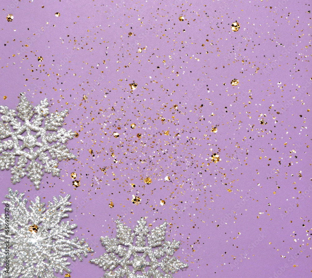 Obraz premium silver glittering snowflake ornaments on violet ground with sparkle and space for text christmas background
