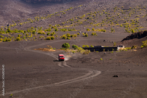 A minibus rides on the ash in the crater of the volcano Pico do Fogo, Cape Verde Islands