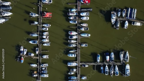 Aerial birds eye view white boats and luxury yachts moored in marina photo