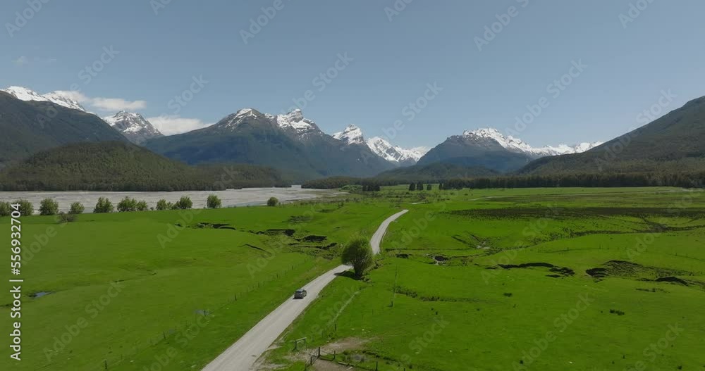 Car driving on scenic road to Paradise in lush green mountain valley, New Zealand Car driving on scenic road to Paradise in lush green mountain valley, New Zealand