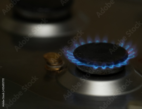 Natural gas burning a blue flames on black background © samy