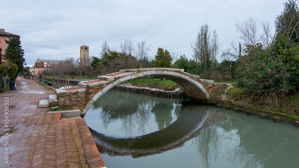 Fototapeta premium Ponte del diavolo - Devil's Bridge in tiny Torcello island, near Venice, Italy, has few residents but often busy with sightseers in summer