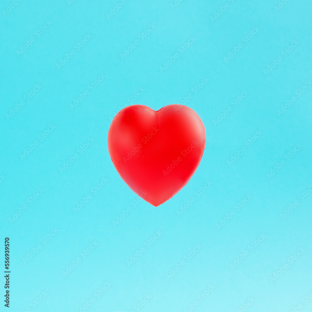 Valentines day background with red heart floating isolated on pastel blue background. Love card for birthday, anniversary. Love is in the air. Romantic moment.
