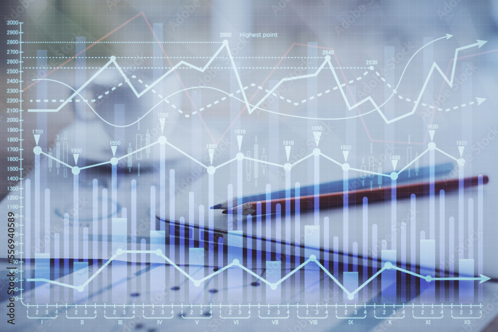 Forex graph hologram on table with computer background. Double exposure. Concept of financial markets. Forex graph hologram on table with computer background. Double exposure. Concept of financial markets.