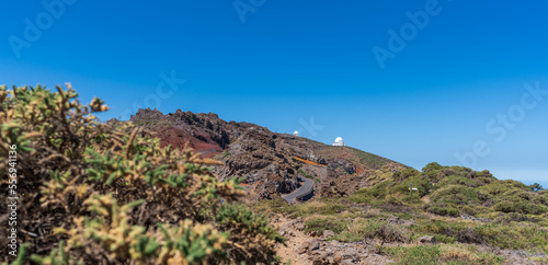 Mountain road and astronomical observatories under blue sky