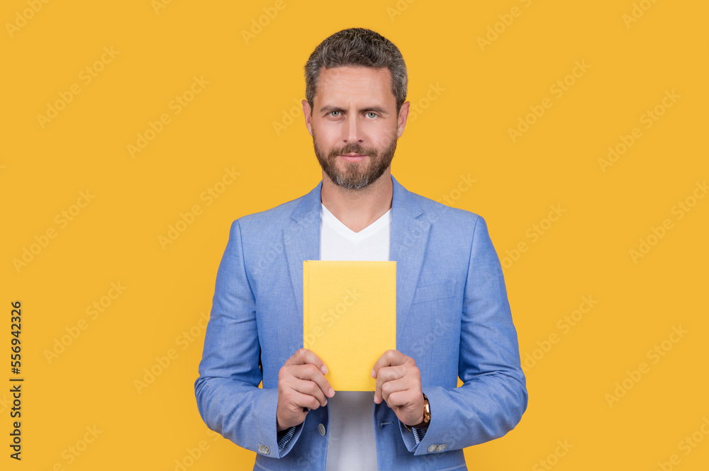 businessman with planner in jacket. studio shot of businessman holding planner. businessman with planner in jacket. studio shot of businessman holding planner.