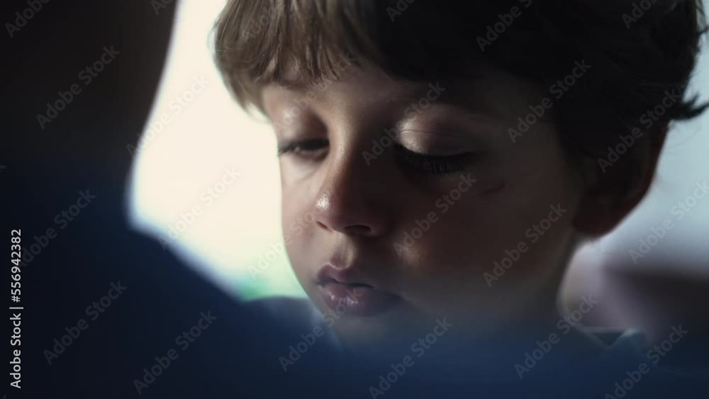 Candid tearful pensive child closeup face. Sad kid with thoughtful expression Candid tearful pensive child closeup face. Sad kid with thoughtful expression