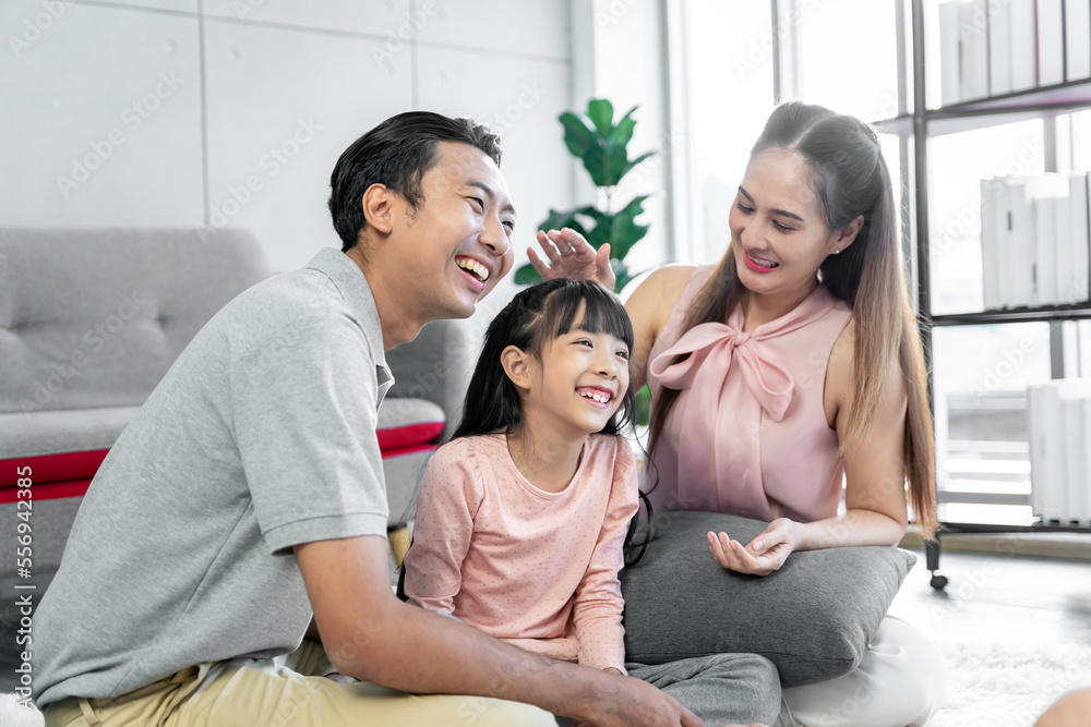 Asian family photo There are fathers, mothers and daughters. The father is the one holding the daughter. and having fun at home on the weekend Asian family photo There are fathers, mothers and daughters. The father is the one holding the daughter. and having fun at home on the weekend