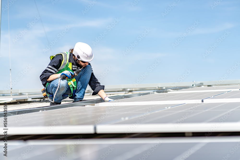 Male engineer installing or checking the working condition of solar panels on the roof or at the height of the factory for saving electricity was broken to use renewable energy from the sun Male engineer installing or checking the working condition of solar panels on the roof or at the height of the factory for saving electricity was broken to use renewable energy from the sun