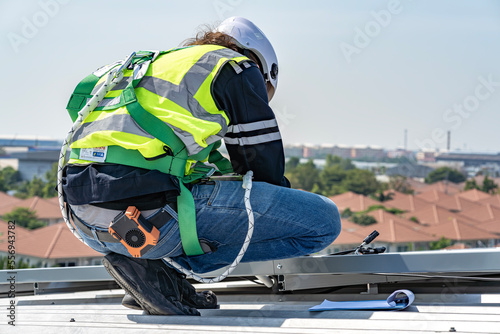 Wallpaper Mural Male engineer installing or checking the working condition of solar panels on the roof or at the height of the factory for saving electricity was broken to use renewable energy from the sun Torontodigital.ca