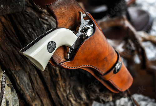 A holster belt with a revolver and ammunition. Western Cowboy style  photo